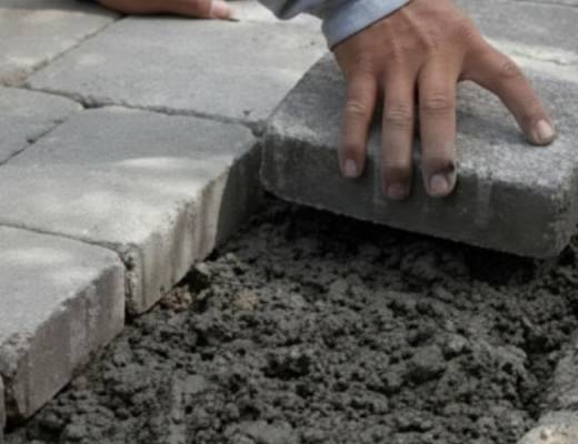 Paver installation process. Pouring a reinforced concrete bond beam along the perimeter for lasting structural support.